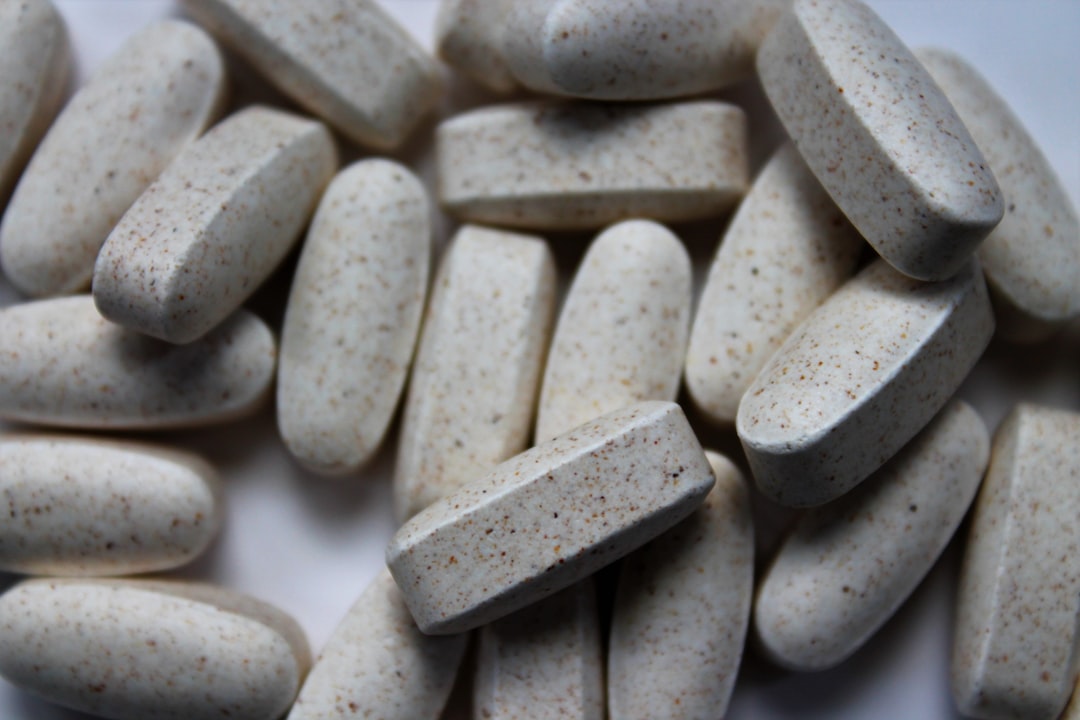 Probiotic capsules beside a glass of water, representing probiotics for bloating and digestive health