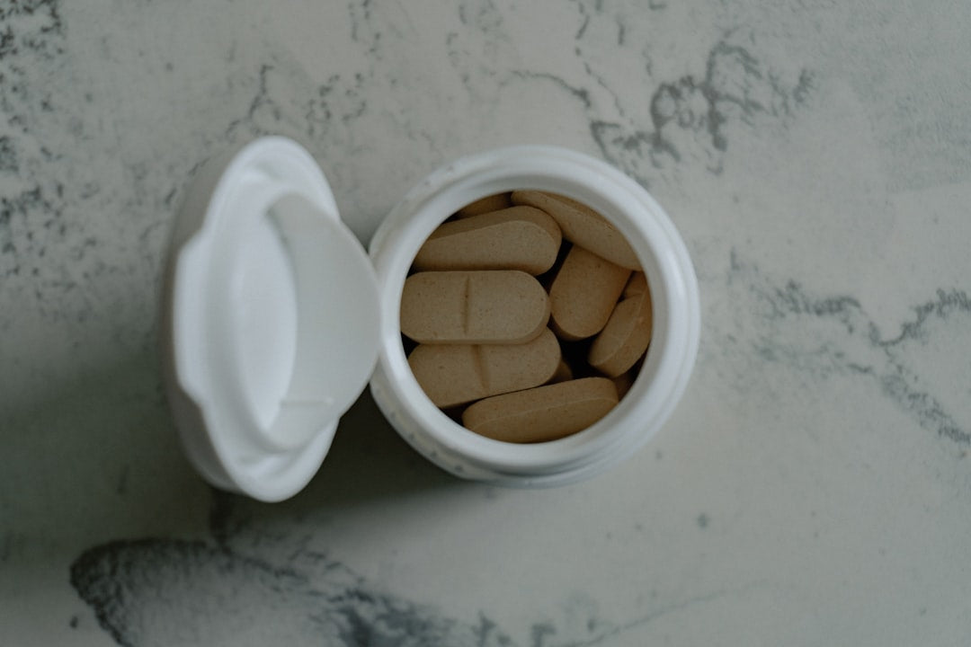 Assorted B vitamin supplement capsules on a neutral surface, representing methylated B vitamins