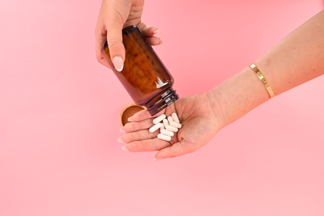 Probiotic supplement capsules on a wooden surface, supporting gut health and bloating relief